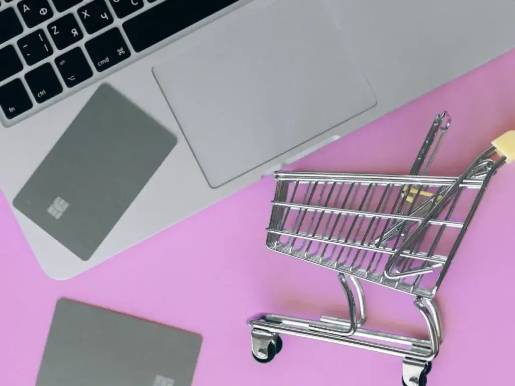 During Amazon Prime Day, a shopping cart is positioned alongside a laptop and credit cards.