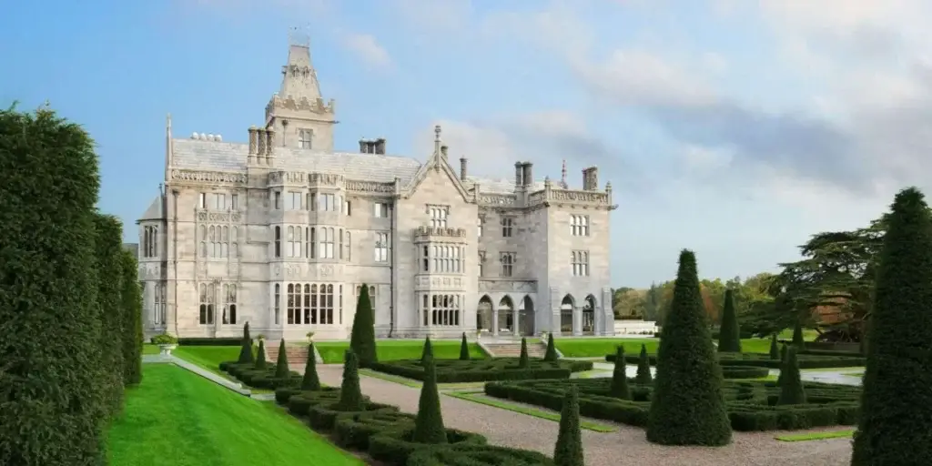 An ornate castle in the middle of a green lawn.